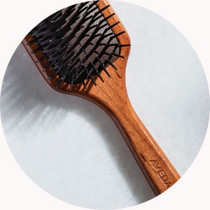 Step 2: Detangle hair with paddle brush